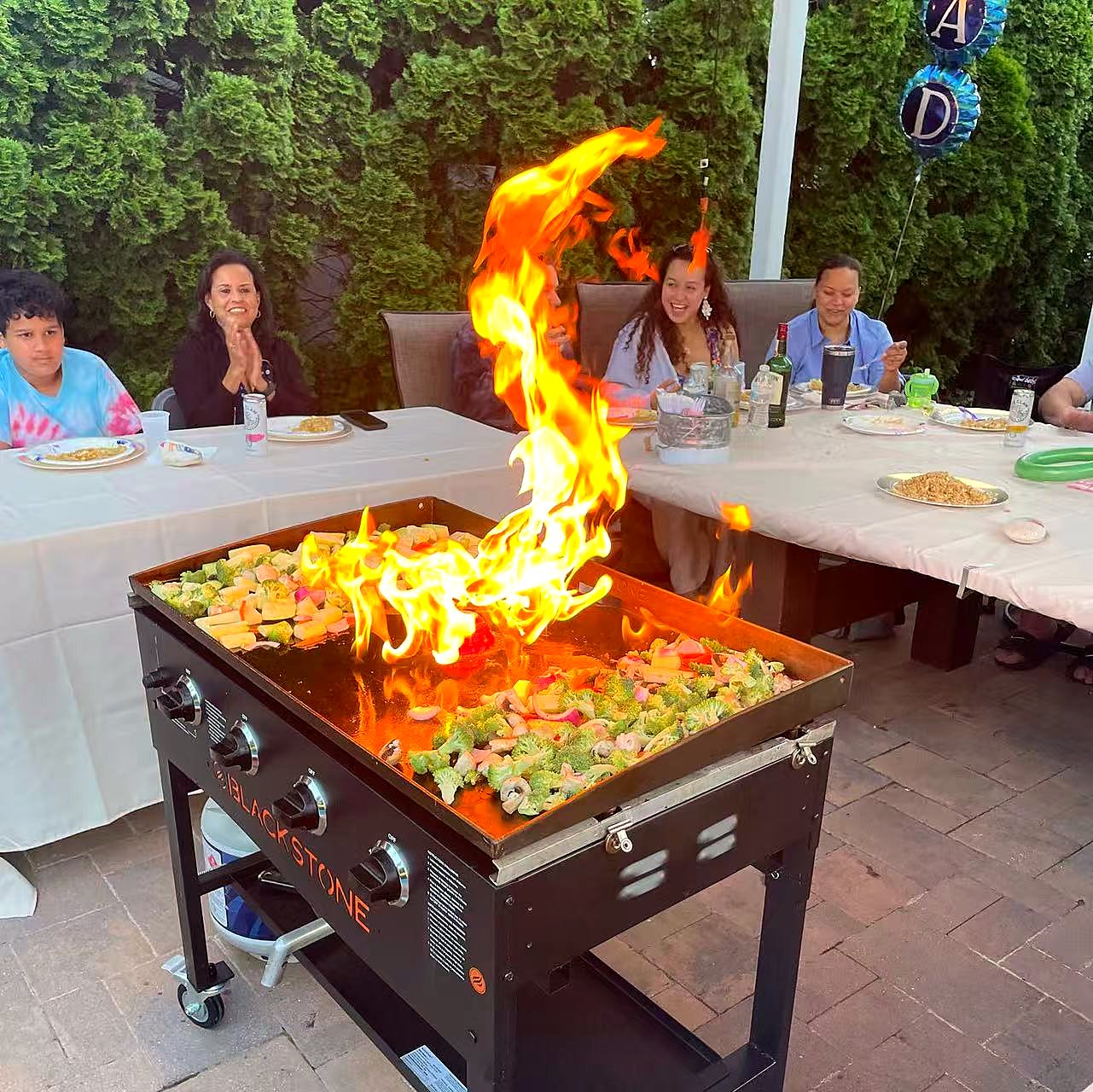 Hibachi chef performing fire show at a Bend backyard party