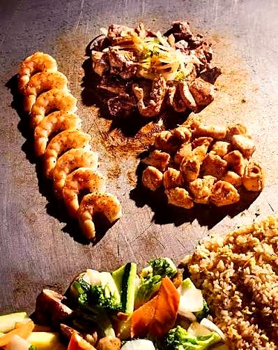 Fresh hibachi food coming off the grill at a private party